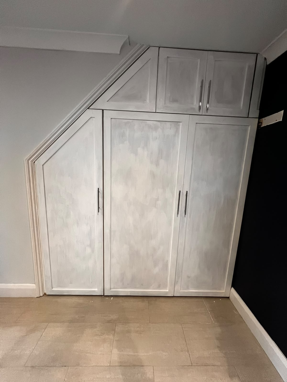 Bespoke understairs fitted wardrobe with shaker doors and hand-painted finish