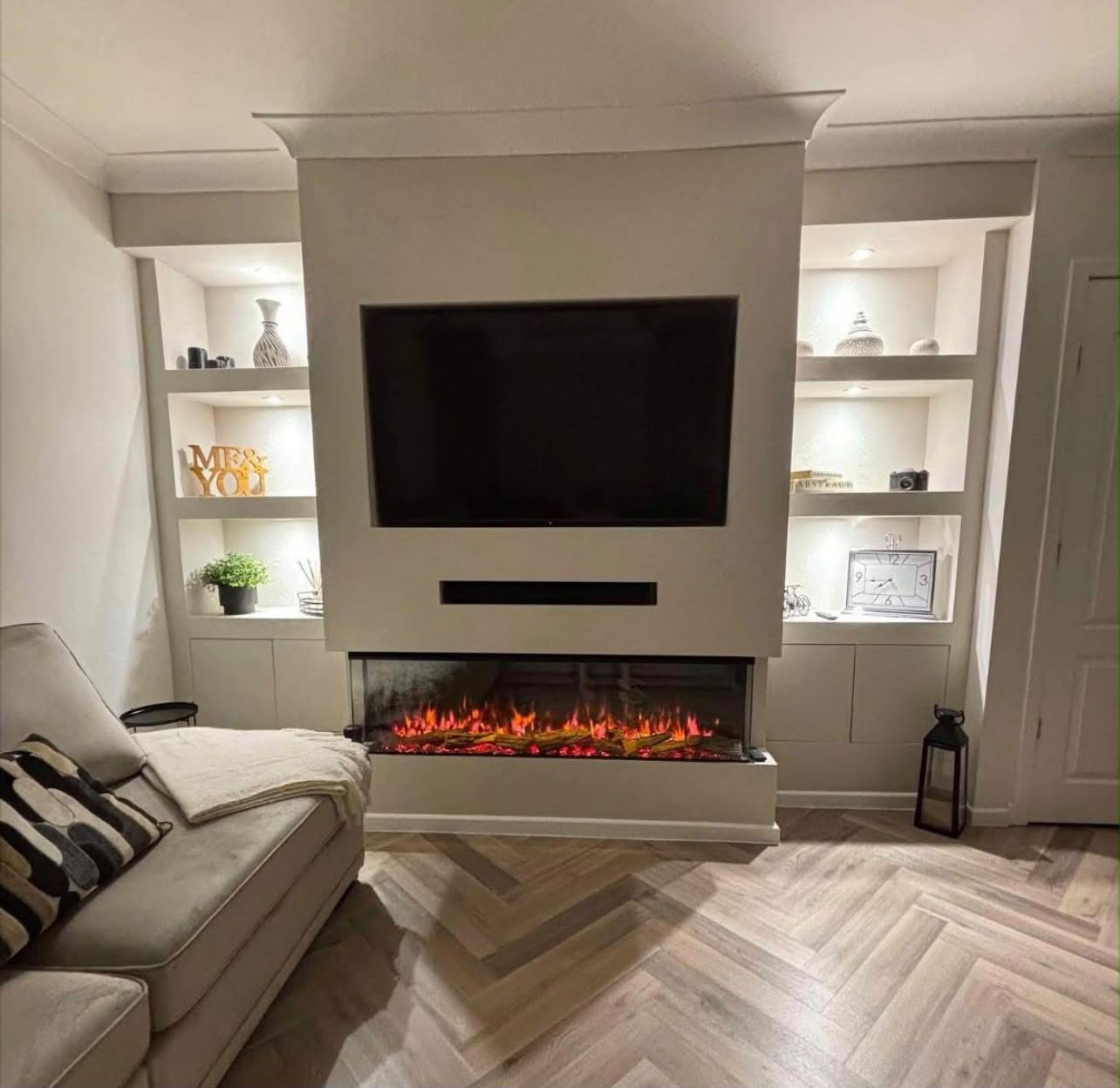 Luxury media wall with electric fireplace and alcove shelving