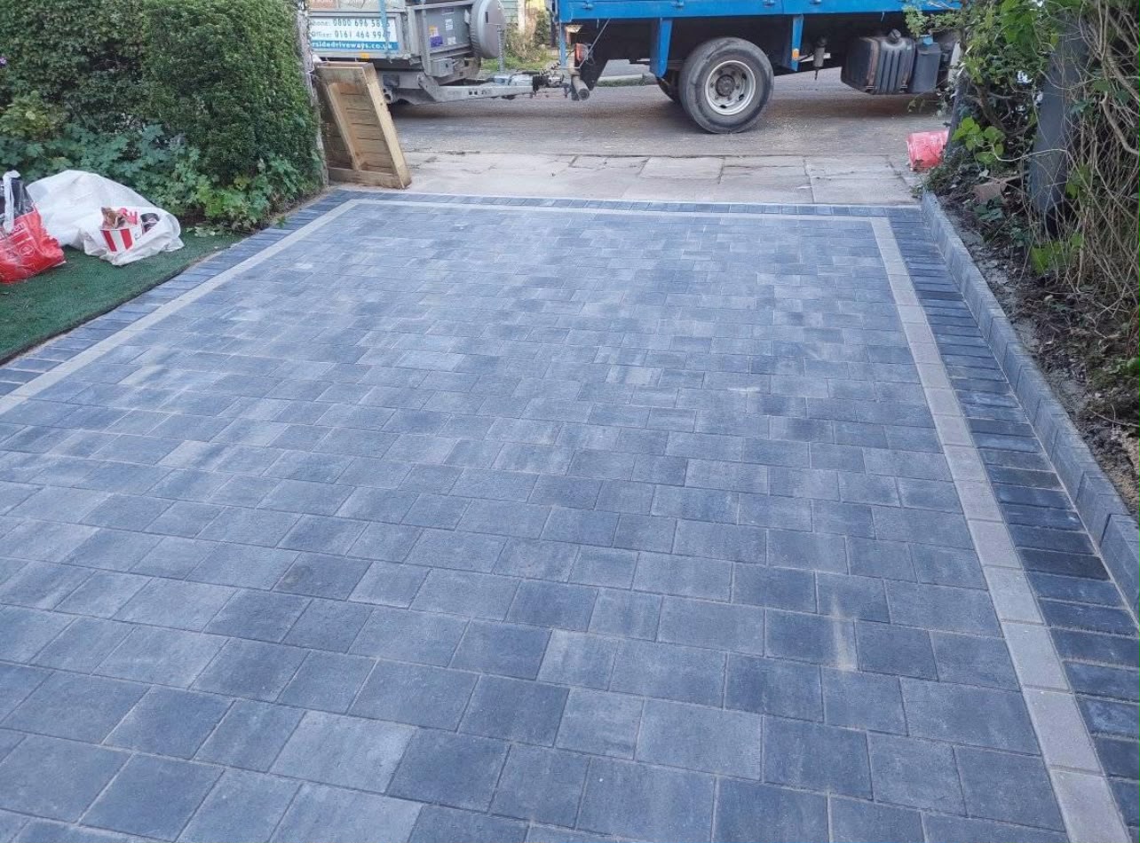 Finished block paved driveway with contrasting charcoal border course