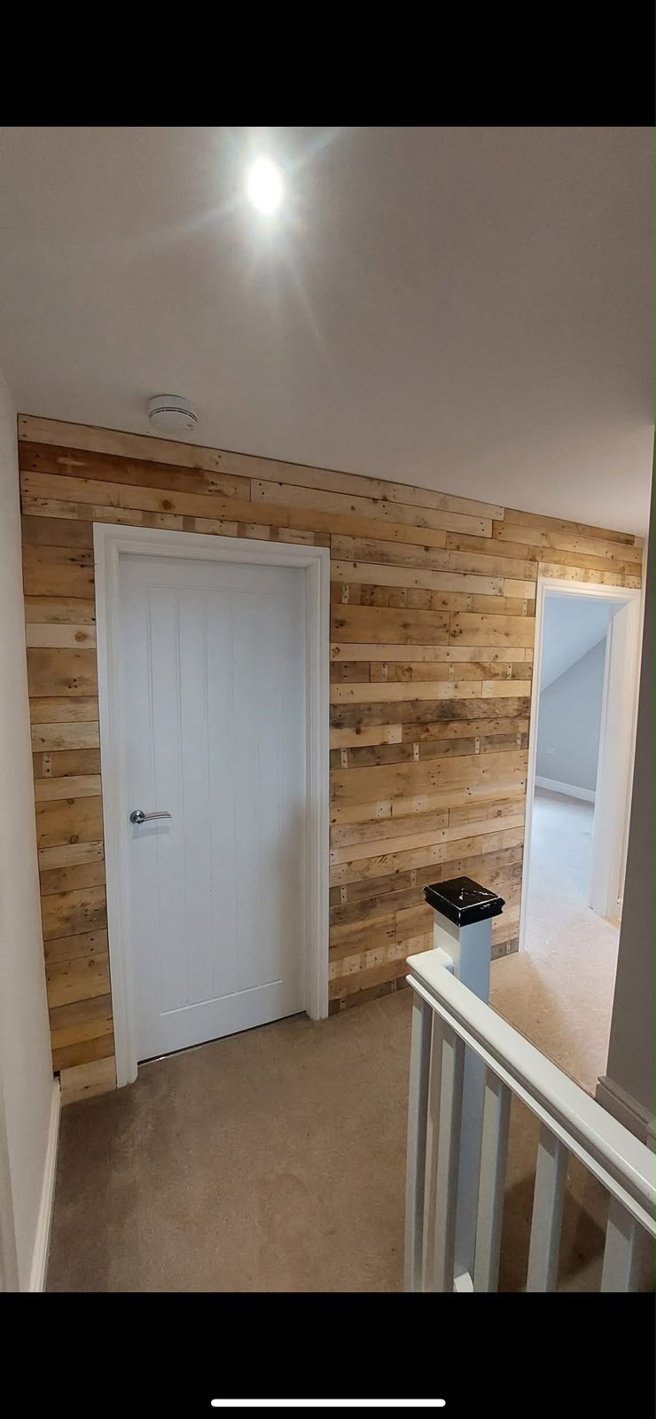 Hallway feature wall with reclaimed timber cladding