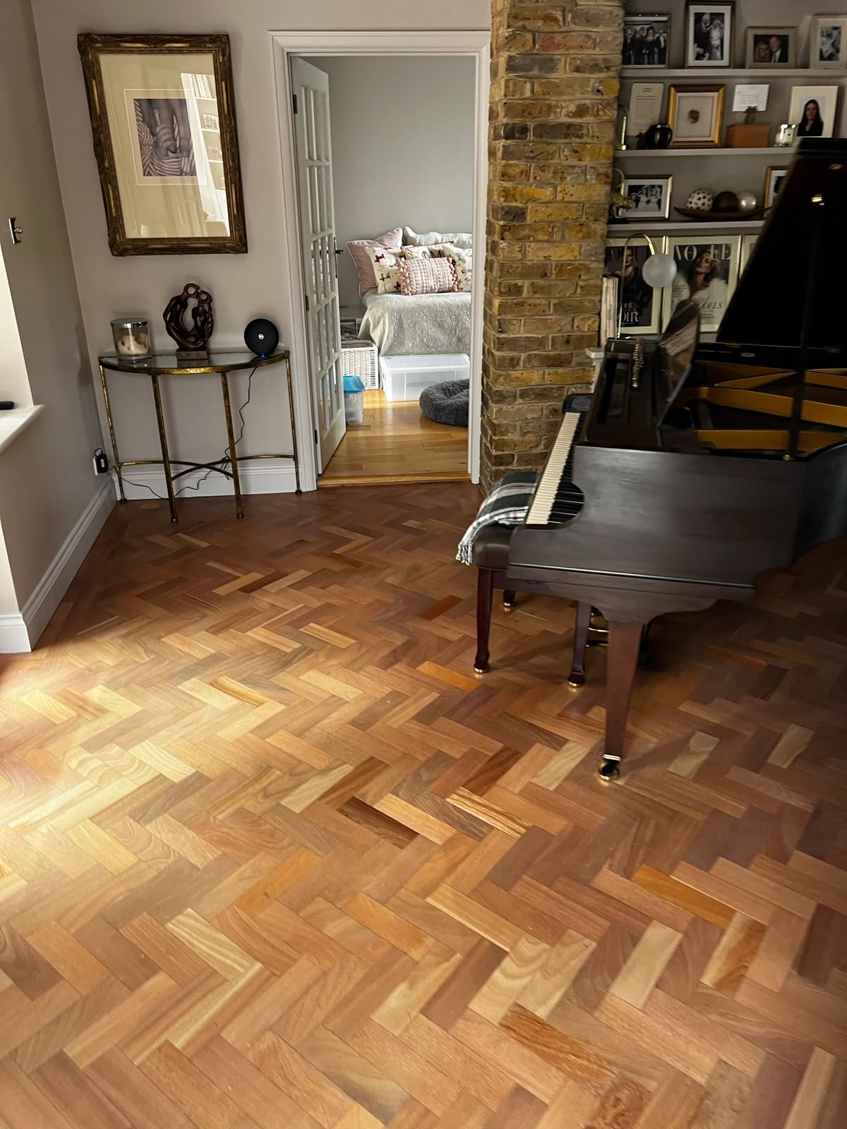 Herringbone parquet wood flooring in period London living room with grand piano