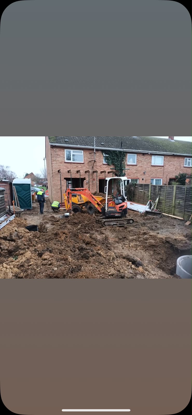 Rear extension groundworks with excavator on residential property